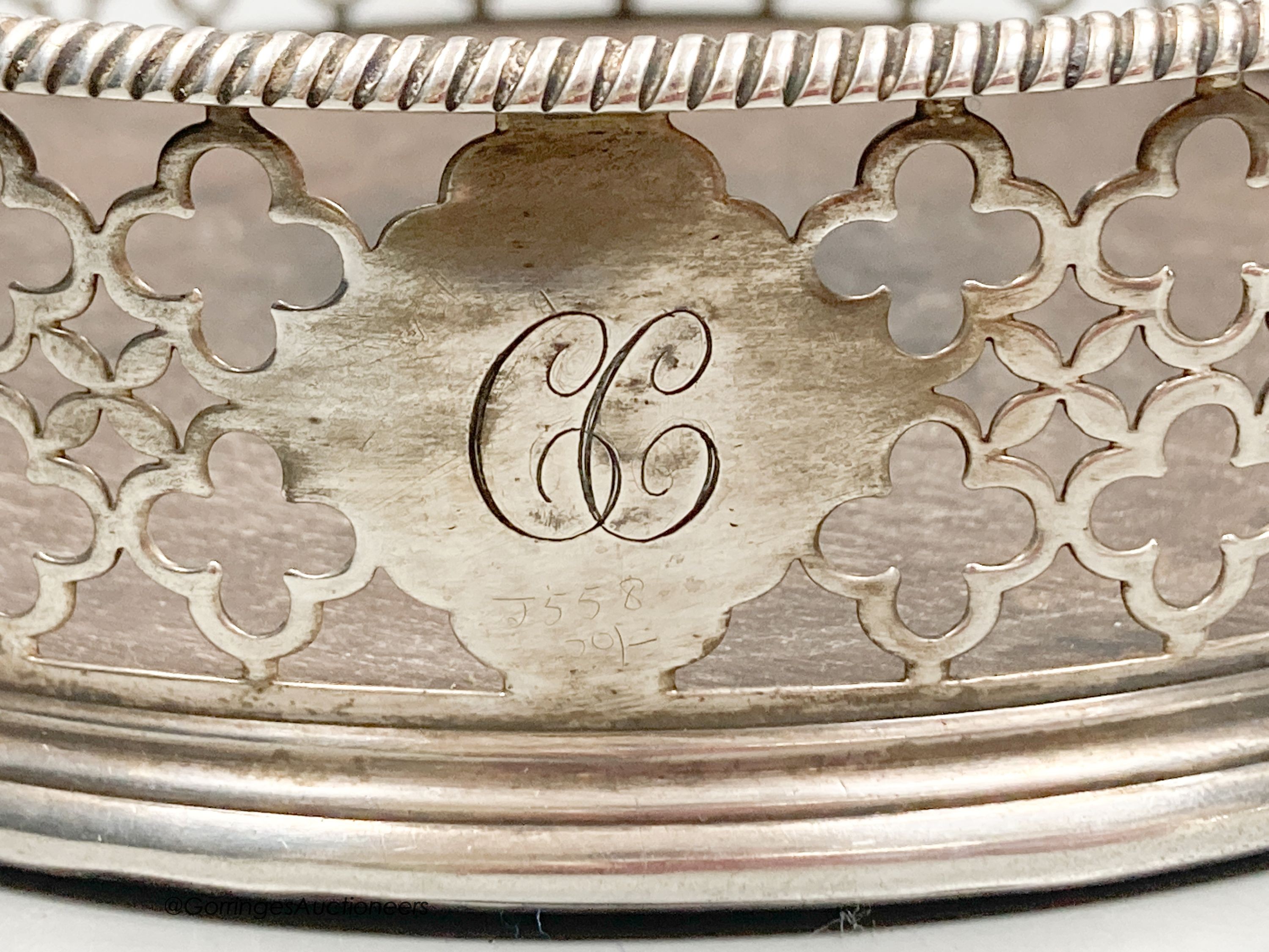 A George III pierced silver mounted wine coaster, Edward Lowe, London, 1775, with engraved initial, diameter 14.2cm.